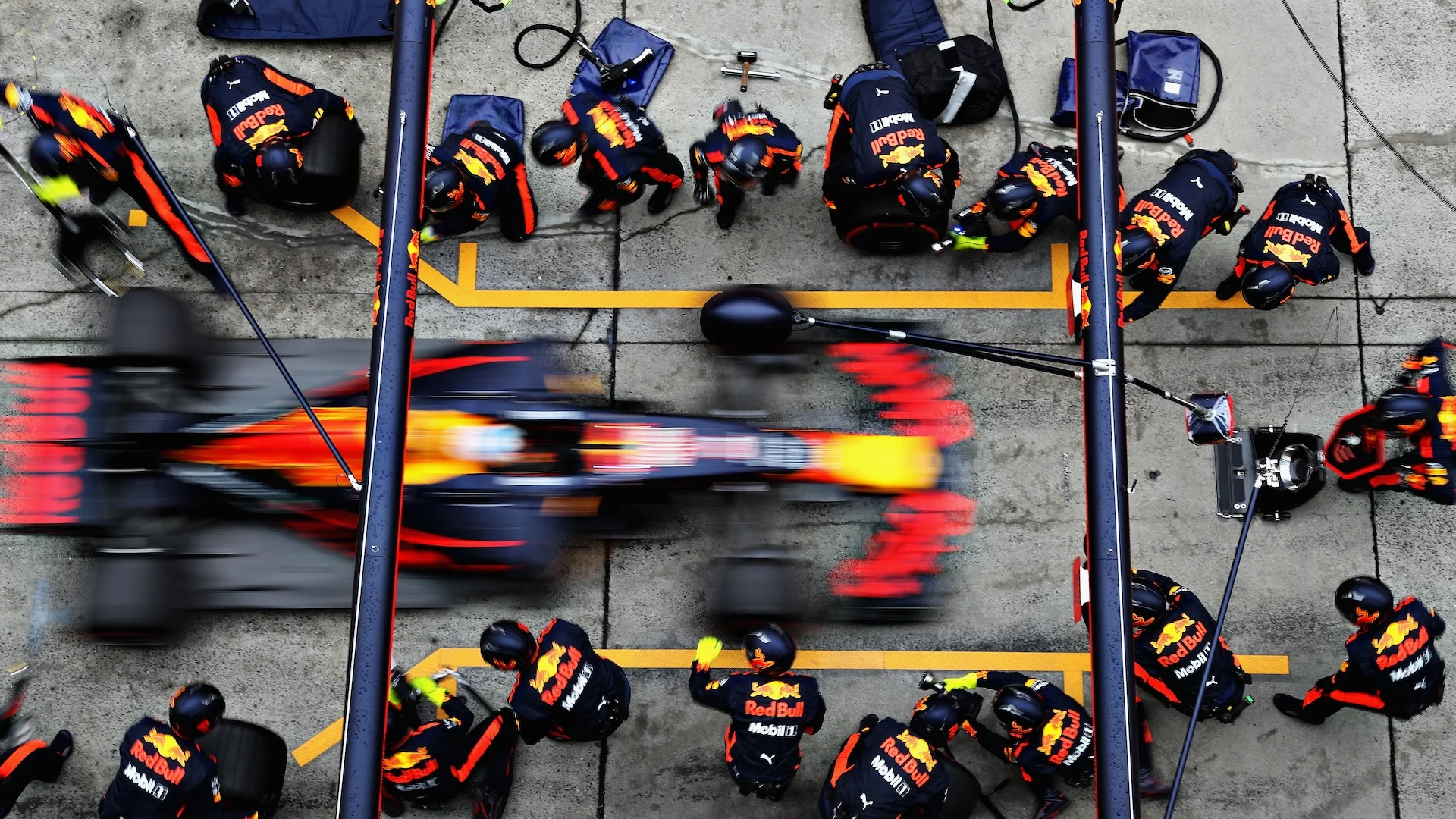 Overhead view of F1 pit stop crew changing tires